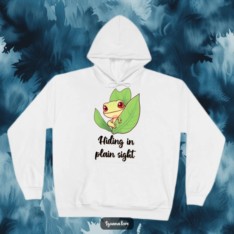 Funny hoodie featuring a cheerful, stylized iguana peeking curiously from behind a large, vibrant leaf, radiating playful mystery.