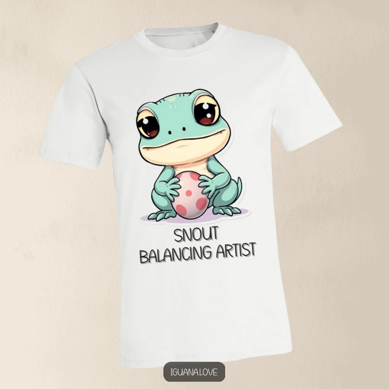 Funny t-shirt of a kawaii iguana with wide eyes attempting to balance a small ball on its snout, exuding playful charm.